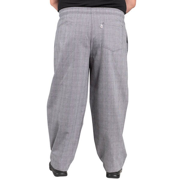 A person wearing Uncommon Chef Glen Plaid chef pants.