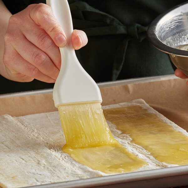 a hand holding a white brush