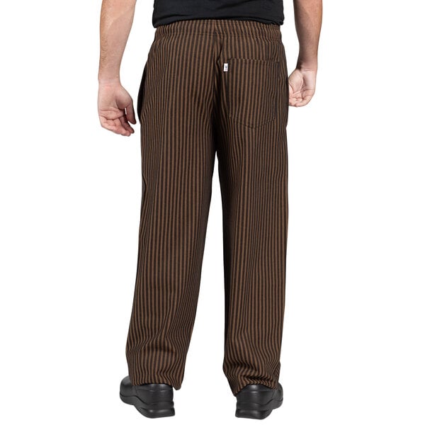 A person wearing Uncommon Chef black and copper striped pants.