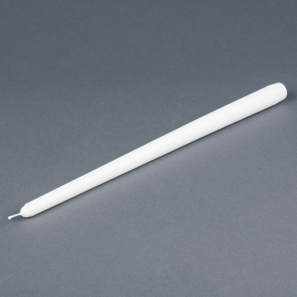 A 15 inch white Will & Baumer taper candle on a gray surface.