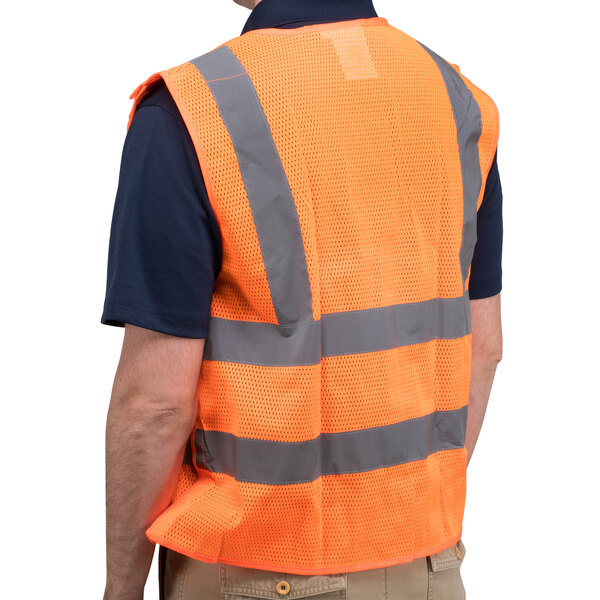 A person wearing a Cordova orange high visibility safety vest with reflective stripes.