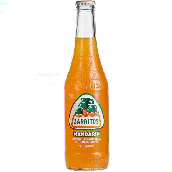 A close up of a glass bottle of Jarritos Mandarin soda with a label.