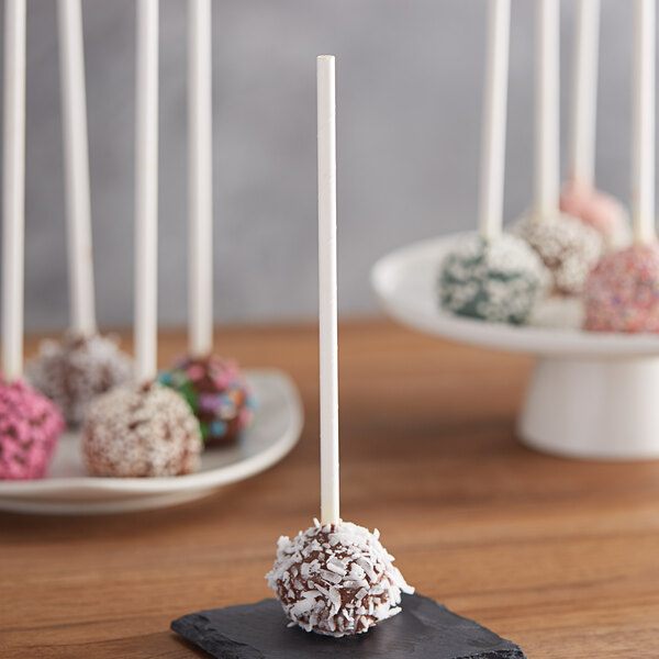 EcoChoice white paper cake pops on a black plate.