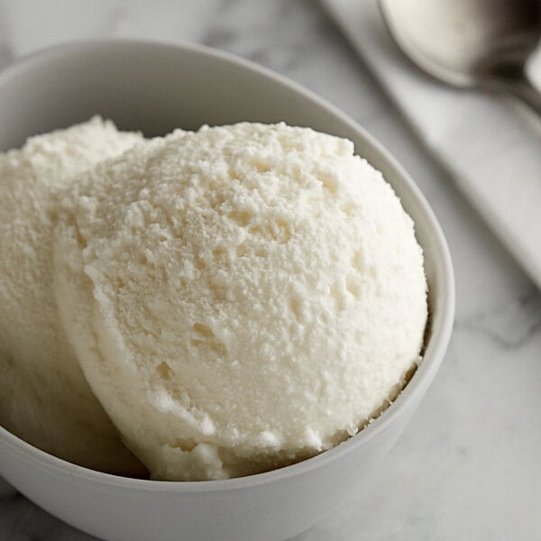 A bowl of I. Rice lemon ice with a spoon.