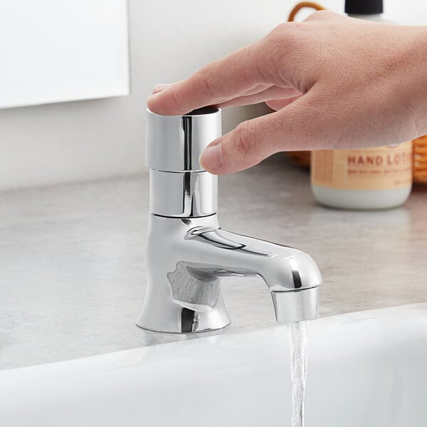 a finger pressing a faucet