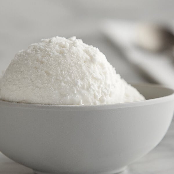 A bowl of I. Rice Horchata water ice base next to a bowl of white ice cream.