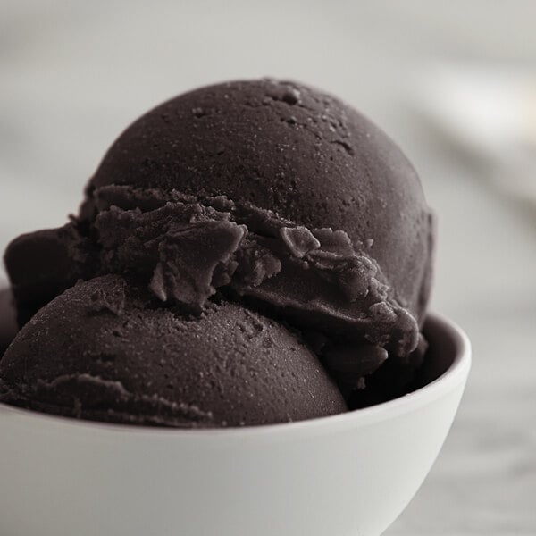 A close-up of a bowl of black raspberry Italian ice.