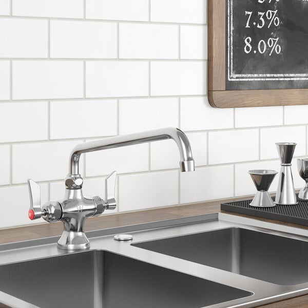 A Waterloo deck-mounted faucet above a kitchen sink with a chalkboard on the wall.