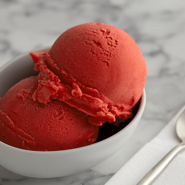 A bowl of red I. Rice strawberry water ice.