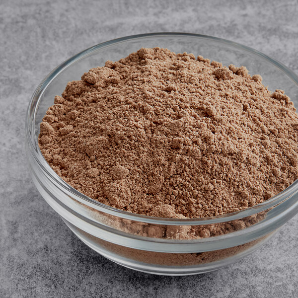 A bowl of Krusteaz Devil's Food Cake Mix, a brown powder.