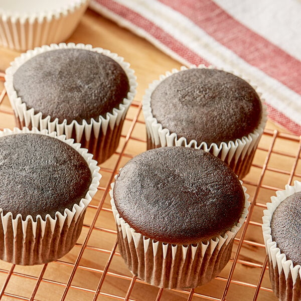 A group of chocolate cupcakes made with Krusteaz Professional Devil's Food Cake Mix on a cooling rack.