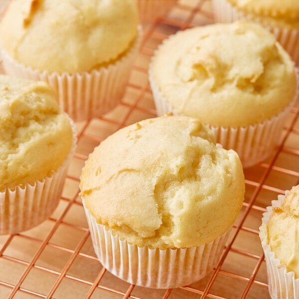 A group of Krusteaz All-Purpose low-fat muffins on a cooling rack.