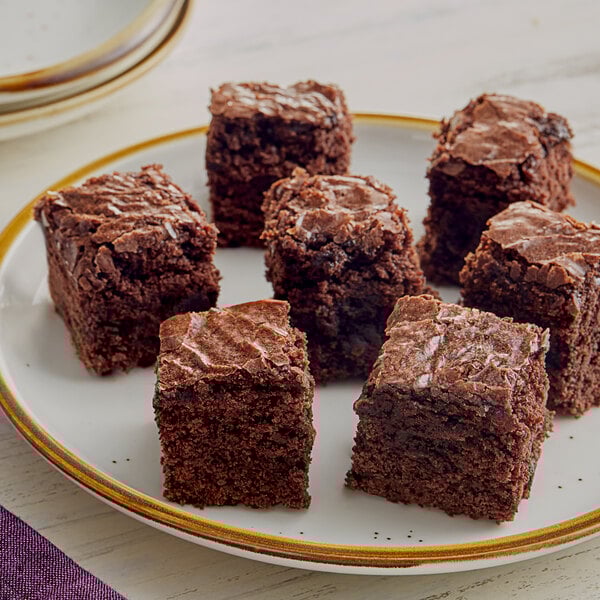 A plate of Krusteaz fudge brownies on a white surface.