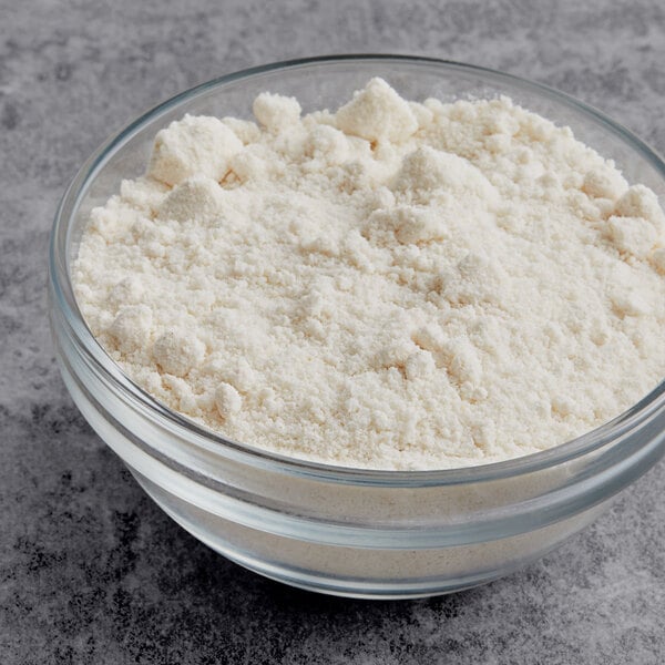 A bowl of Krusteaz Extra Moist White Cake Mix on a table.