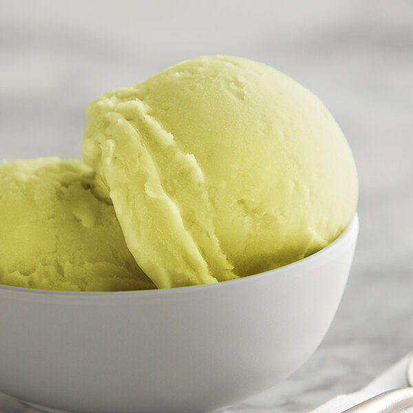 A close-up of a bowl of yellow and white I. Rice pineapple water ice.