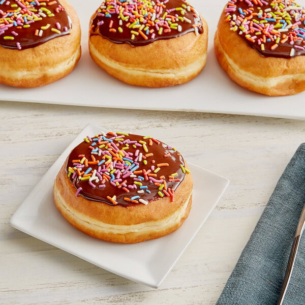 A plate of Krusteaz donuts with sprinkles on top.