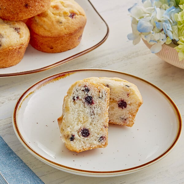 A plate of Krusteaz blueberry muffins with blueberries on top.