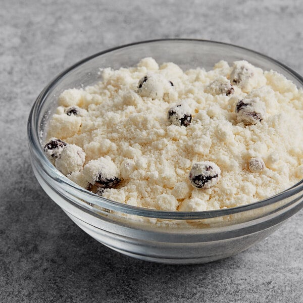 A bowl of white powdered Krusteaz Blueberry Muffin Mix.
