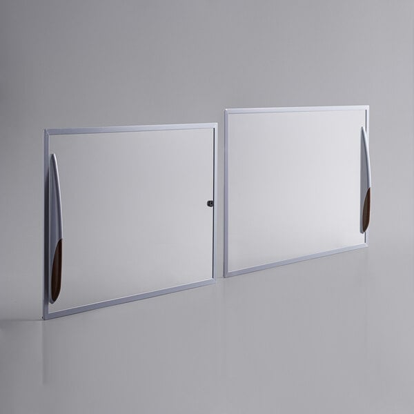 Two white rectangular glass lids with brown handles for an Avantco freezer.