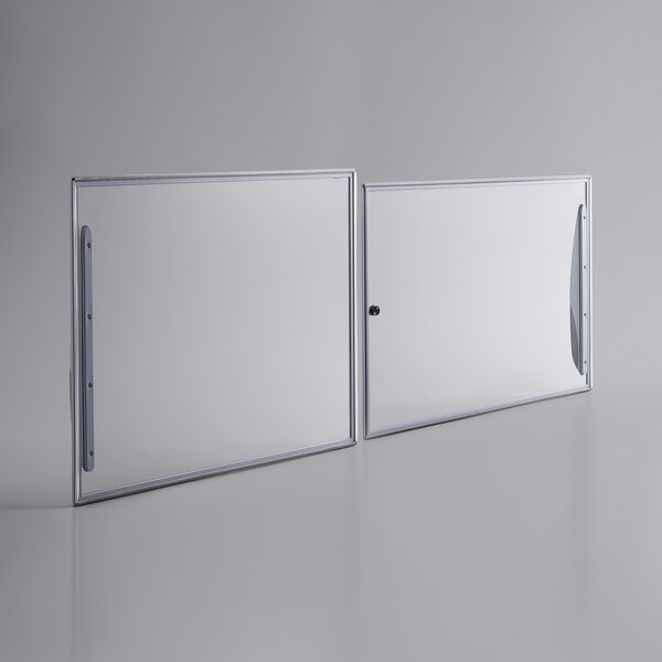 Two white rectangular glass lids with metal handles.