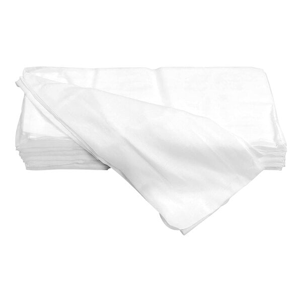 A stack of folded white cloth sheets, with one sheet partially unfolded on top.