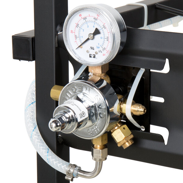 A close-up of a Servend bag in box rack pressure gauge on a metal frame.