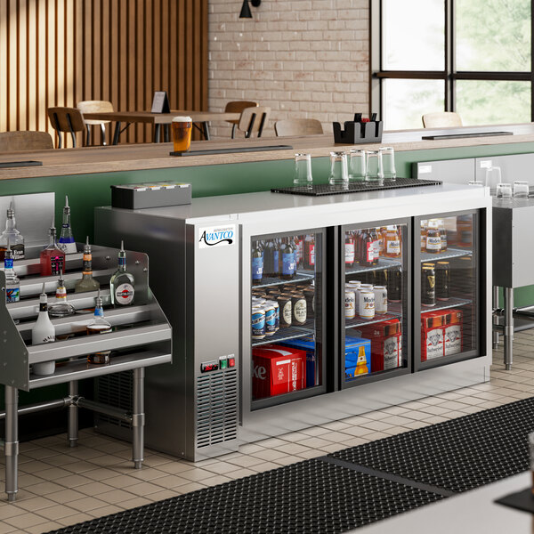 An Avantco back bar cooler with drinks on a metal shelf.
