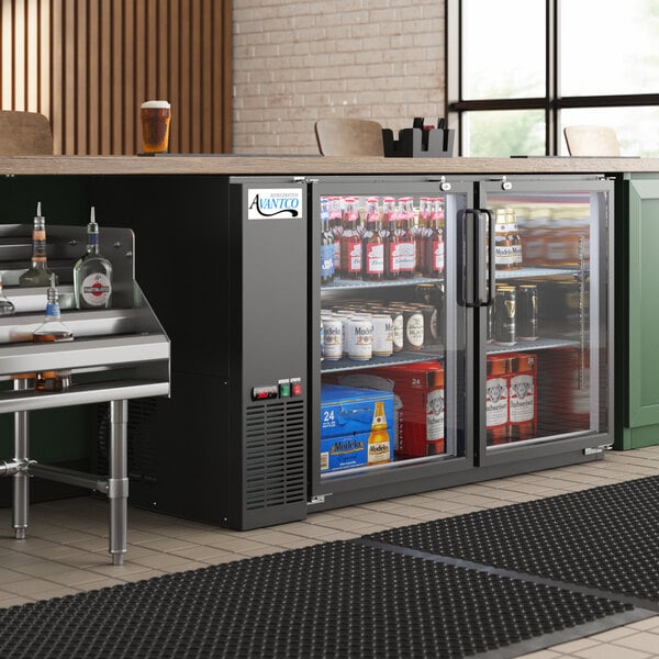 An Avantco back bar refrigerator with drinks on a metal shelf.