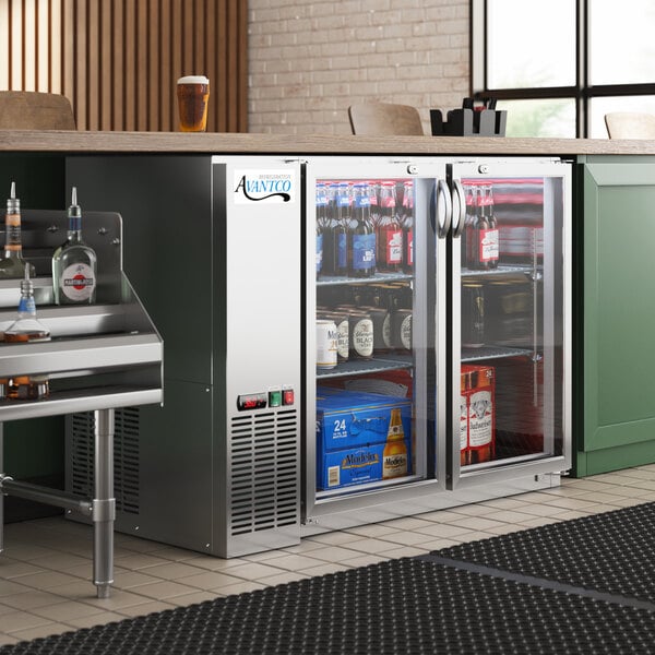 An Avantco back bar refrigerator with drinks inside on a counter.