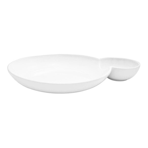 A white porcelain round bowl with two compartments, one large and one small, designed for serving food and sauces.