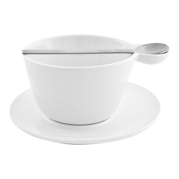 A bright white round porcelain saucer with a cup and spoon placed on top.