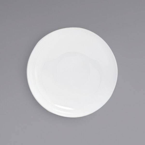 A bright white low round porcelain bowl with a white background.