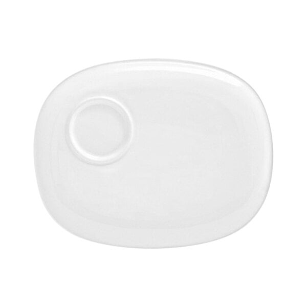 A bright white oval porcelain plate with a built-in well, measuring 10 1/2 by 8 1/4 inches.