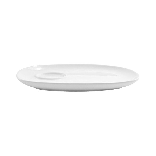 A bright white oval porcelain plate with a built-in well, designed for serving, measuring 10 1/2 by 8 1/4 inches.