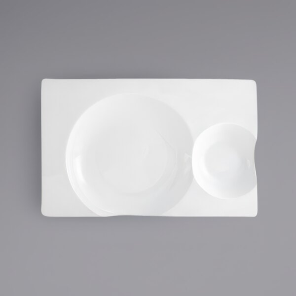 A white rectangular porcelain plate with two compartments.