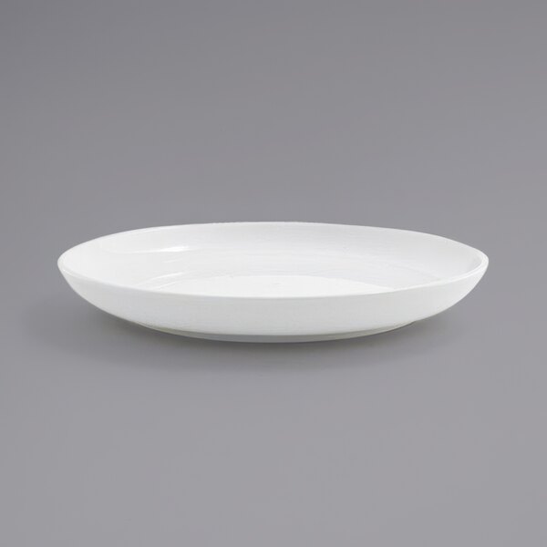 A white plate with a rim on a gray background.