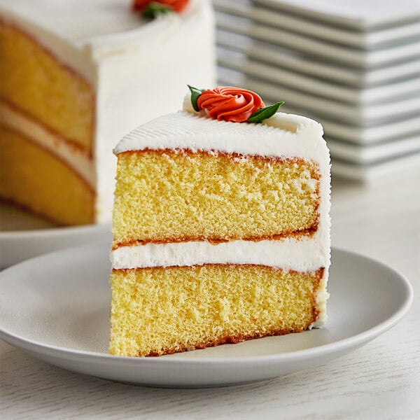 A slice of Bob's Red Mill gluten-free vanilla yellow cake with a rose on top.