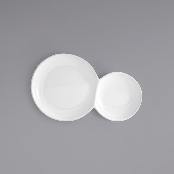 Two bright white porcelain plates with two compartments, each with a circle inside.