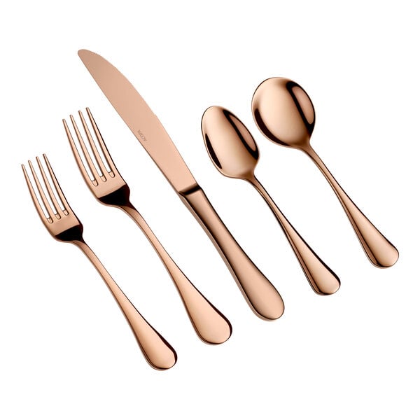Five pieces of rose gold-colored flatware, including two forks, a knife, and two spoons, are arranged side by side on a white background.