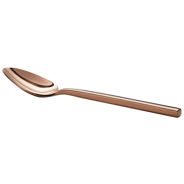 A close-up of an Acopa Phoenix stainless steel spoon with a rose gold metal handle.