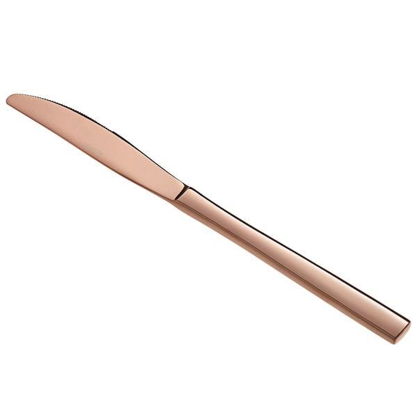 An Acopa Phoenix rose gold stainless steel dinner knife with a wooden handle.