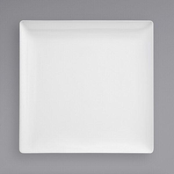 A Front of the House bright white square porcelain plate on a gray background.