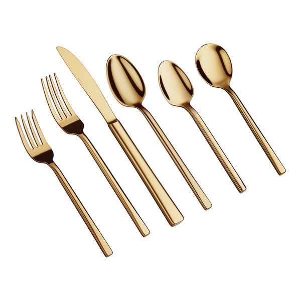 Six pieces of gold-colored flatware, including two forks, one knife, and three spoons, are arranged side by side on a white background.