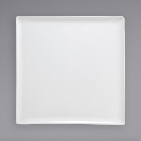 A Front of the House bright white square porcelain plate on a grey background.