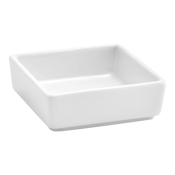 A small, square, bright white porcelain ramekin.