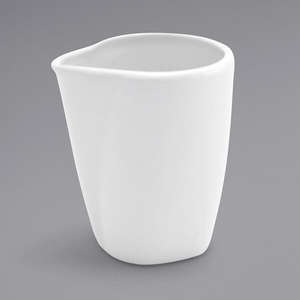 a white cup with a curved edge