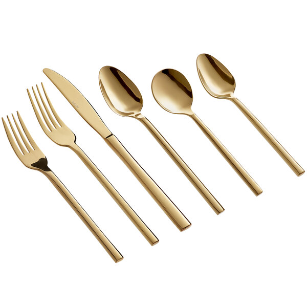 A close-up of a gold Acopa Phoenix stainless steel spoon.