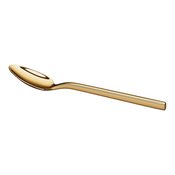 A gold-colored metal teaspoon with a smooth, reflective finish and a slightly curved handle.
