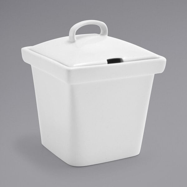 A white square porcelain pot with a notched lid.