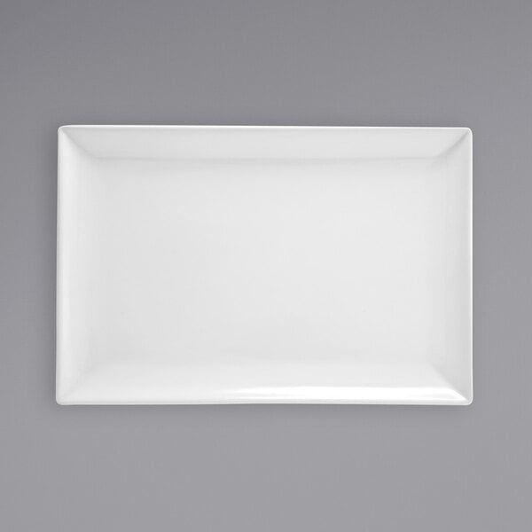 A white rectangular Front of the House porcelain plate on a gray surface.